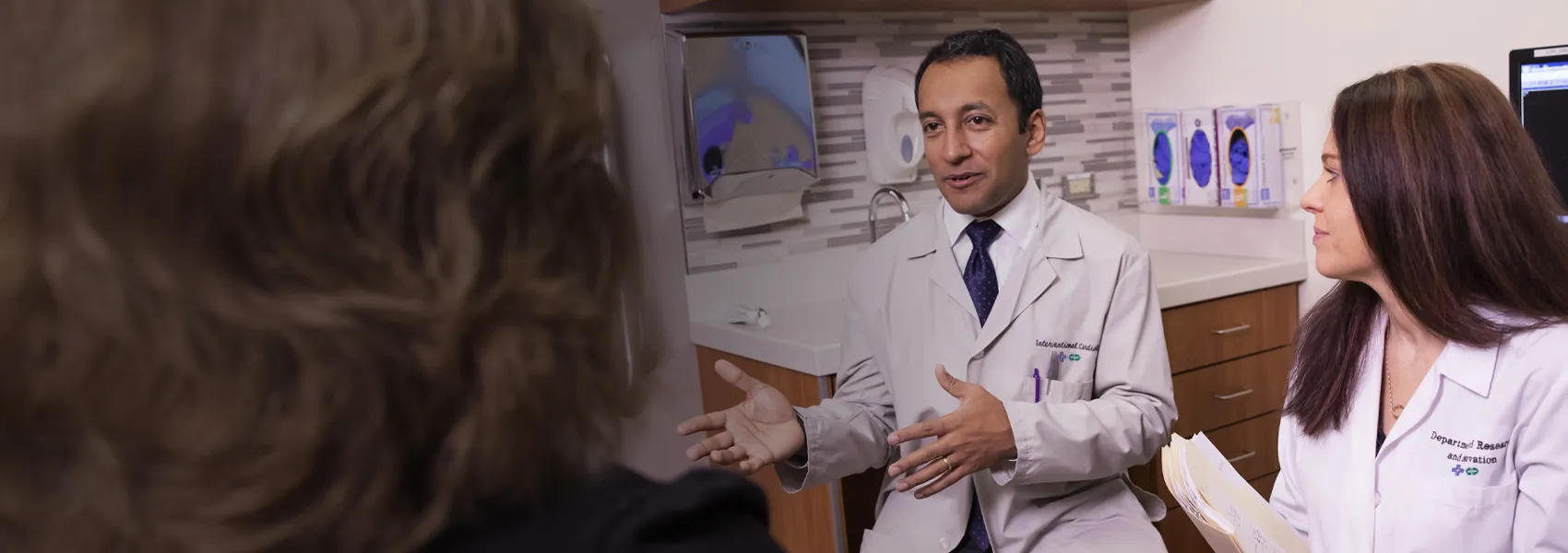 Two providers speaking with patient