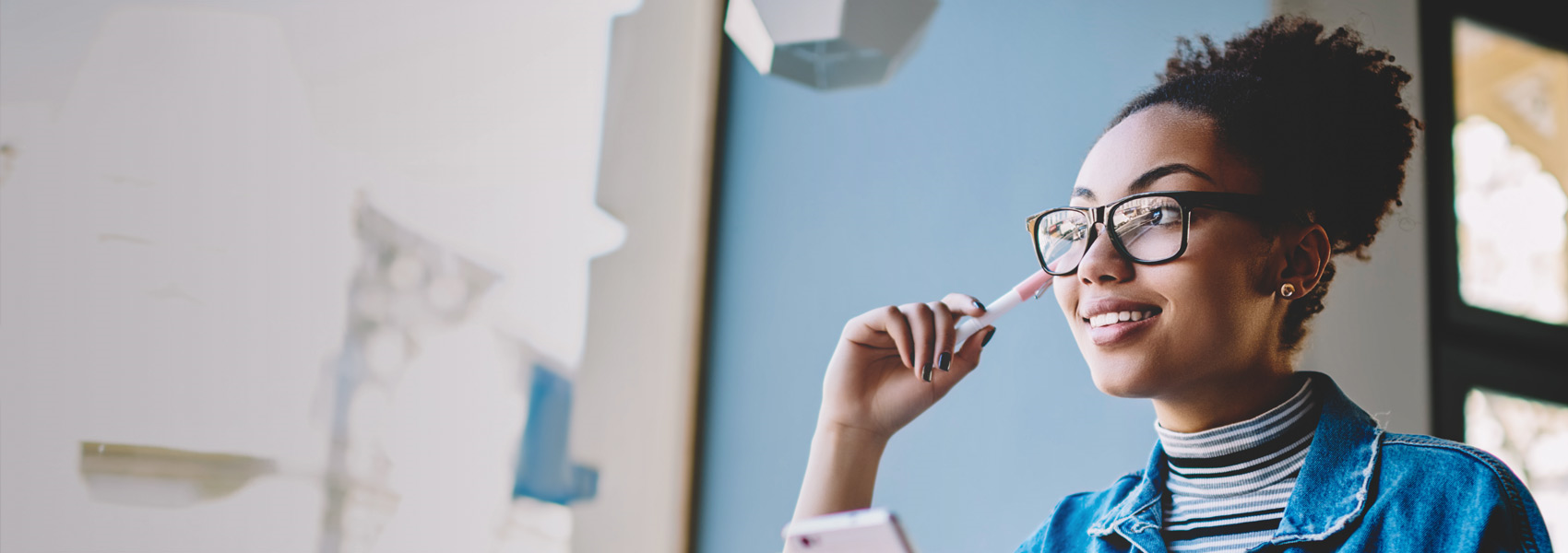 Woman smiling with pen in right hand