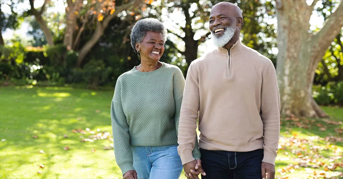 Two elderly people walking together