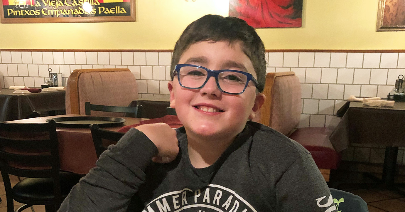 Kid sitting in a diner. 