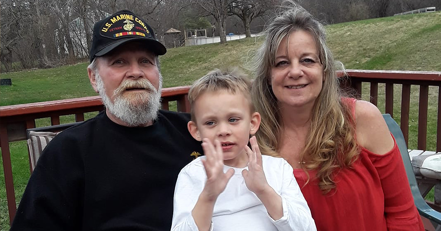 Family sitting on a deck.