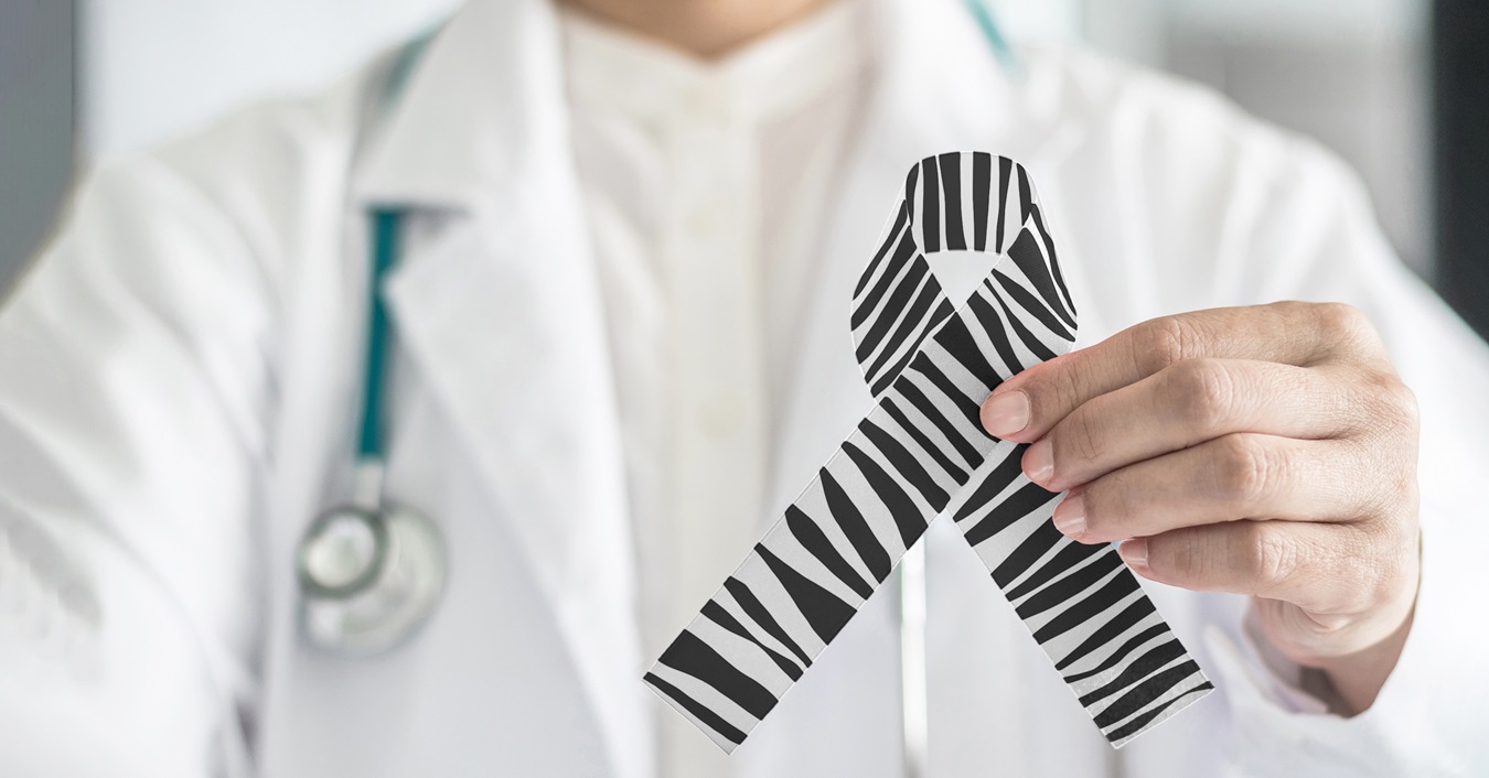 Provider holding a ribbon made of a zebra pattern.